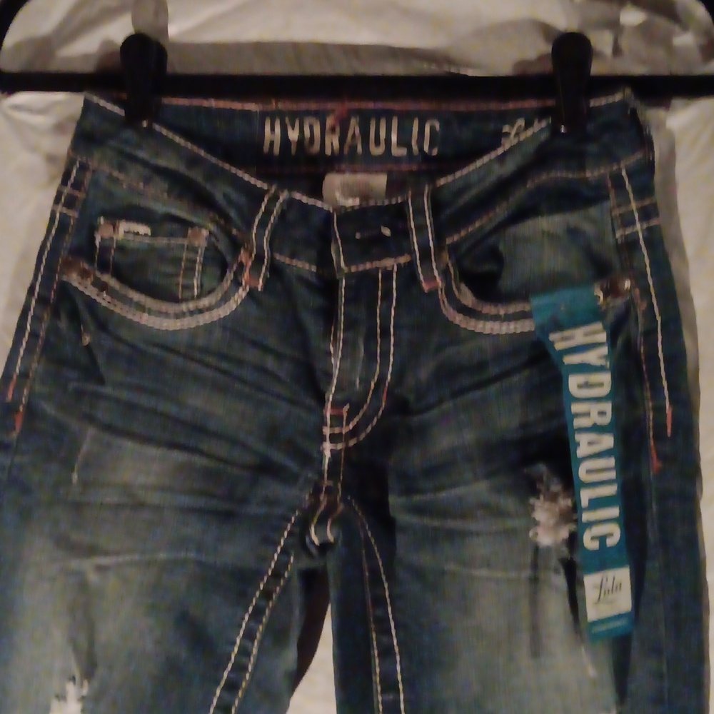 Nwt curvalicious boot cut Jean with rips and white stitching, button pockets